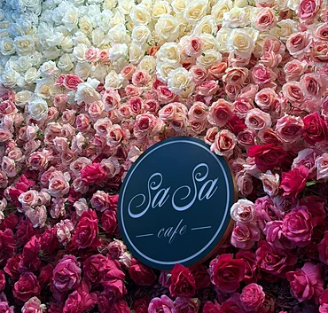 Sasa Cafe flower wall with the cafe logo