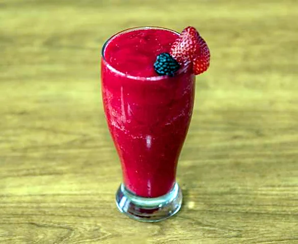 Strawberry milkshake garnished with a fresh strawberry
